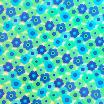 The image is a vibrant and colorful collage of various blue and green flowers, creating a lively and cheerful visual effect.