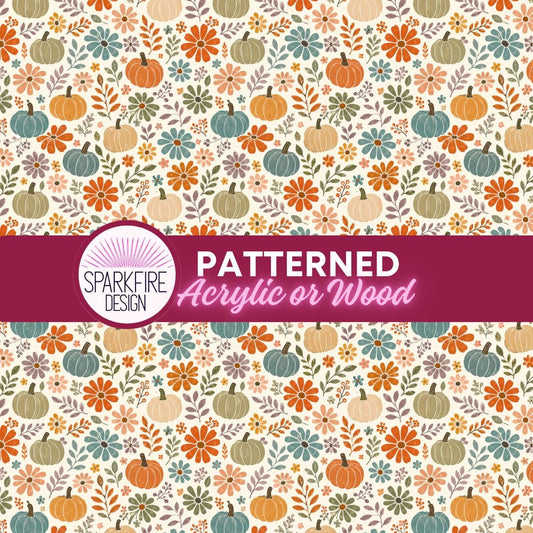 The image is a patterned design featuring various autumn-themed elements such as pumpkins, flowers, leaves, and stems on white acrylic.