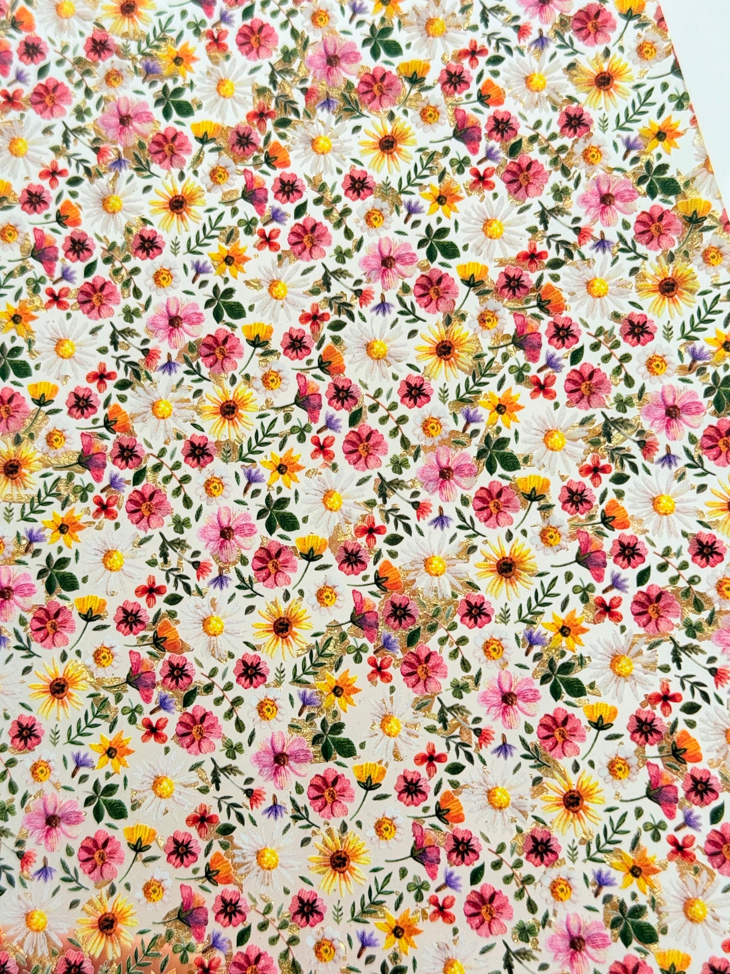 The image is a vibrant and colorful collage of various flowers and leaves, creating a lively and visually appealing pattern.
