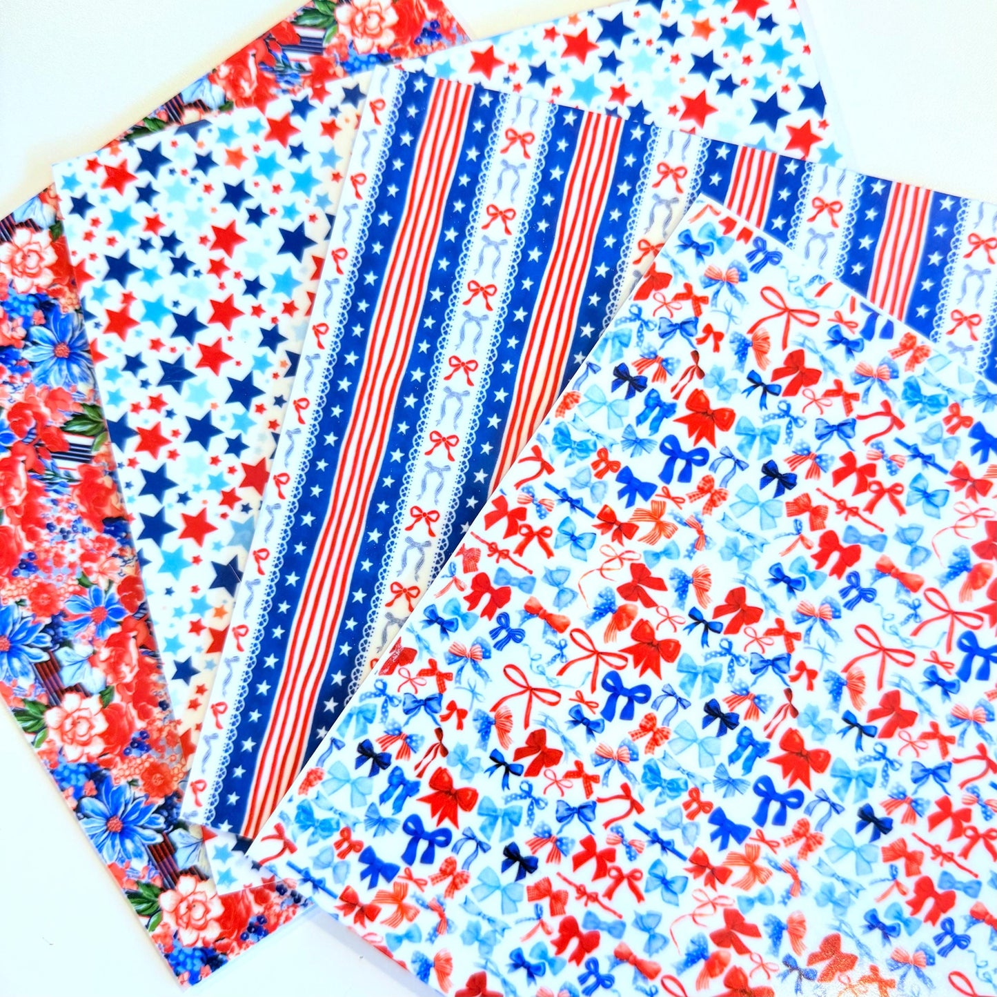 a collection of colorful acrylic pieces with patriotic designs, including stripes, stars, and bows.