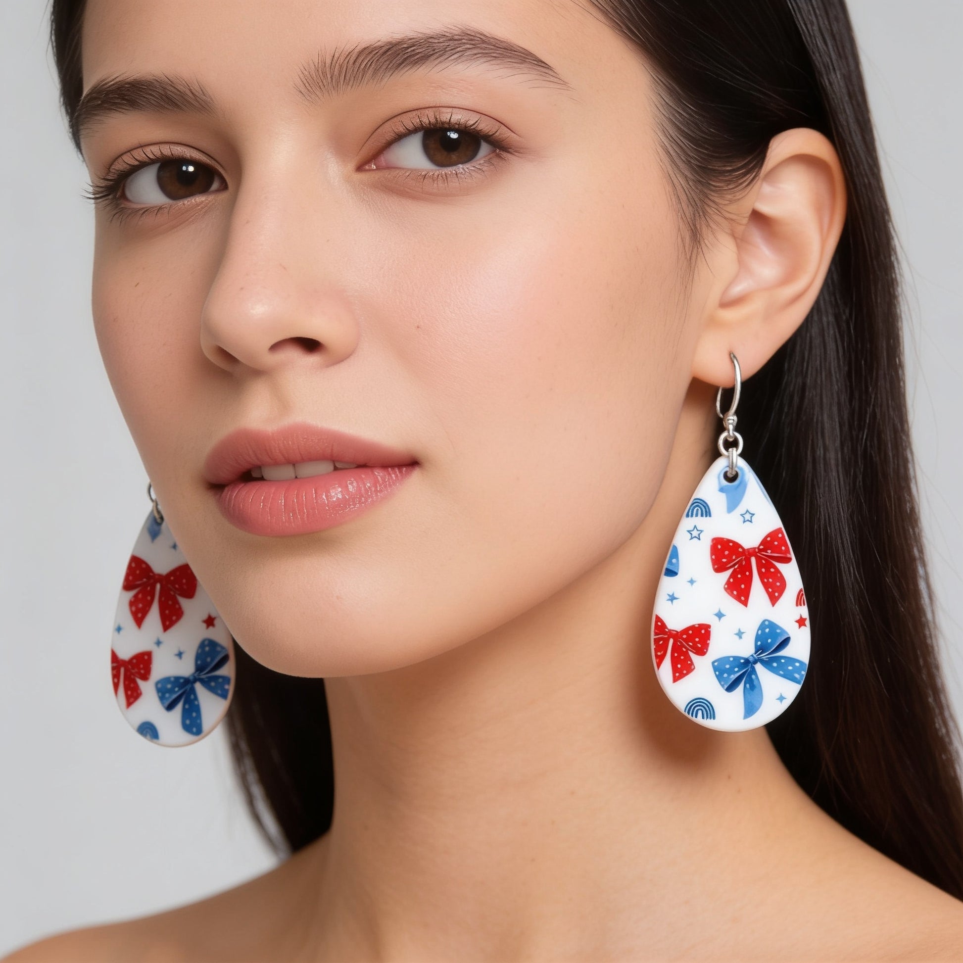 A close-up portrait of a woman wearing large earrings with a bow design.
