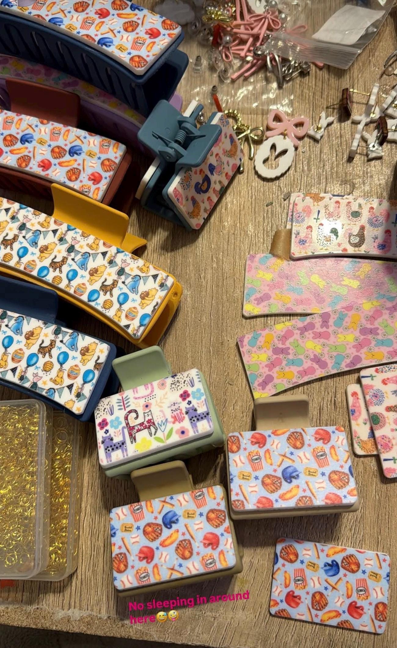 various colorful plastic clamps and accessories arranged on a wooden surface.