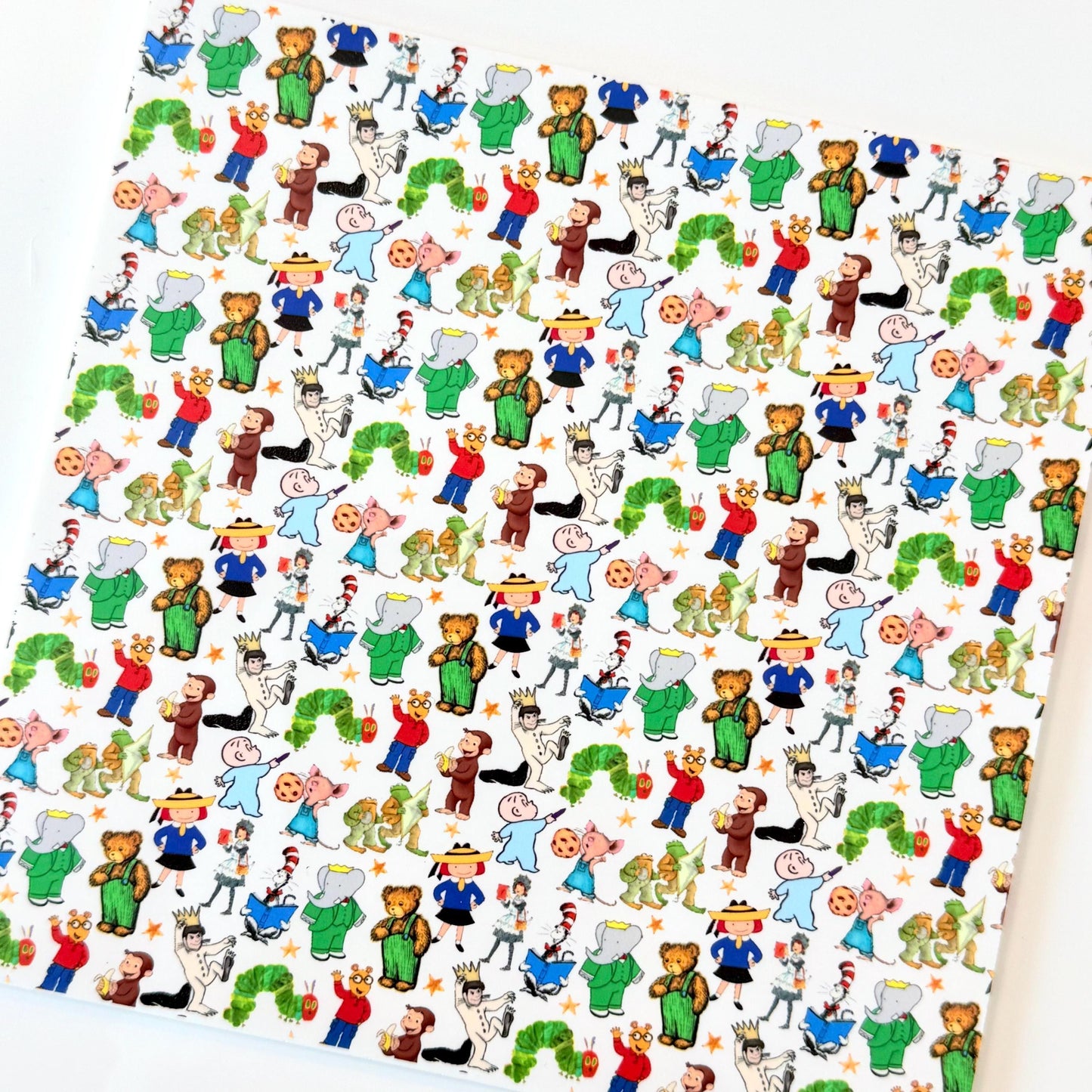 The image is a repeating pattern of various cartoon characters and animals, including a caterpillar, teddy bears, and other whimsical figures, all set against a white background.