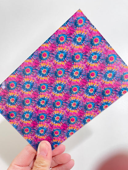 a hand holding a piece of paper with a pattern on it