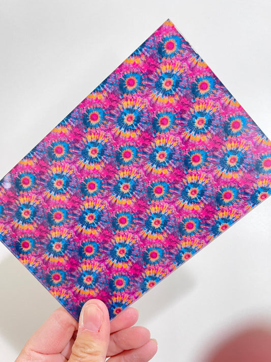 a hand holding a piece of paper with a pattern on it